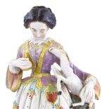 A 19th century Continental porcelain figure of a woman with a lamb, height 29cm