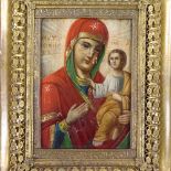 A 19th century Russian/Greek painted icon in ornate pierced brass frame, in stained wood glazed