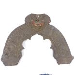 An Oriental relief moulded brass door pediment, width 80cm, height 58cm