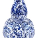 A large Delft tin-glazed pottery double gourd vase, with hand painted exotic bird decorated