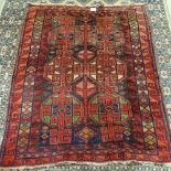 A Turkish red ground wool rug, geometric patterns and border, 200cm x 155cm