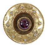 An unmarked yellow metal foil back cabochon tourmaline and split-pearl circular brooch in rope twist