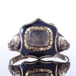A 19th century unmarked gold and black enamel mourning ring, central glass-fronted shield-shaped
