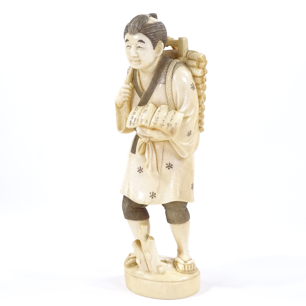 A Japanese ivory okimono, man carrying kindling wood and a book, Meiji Period, signed under base, - Image 2 of 6