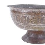 An Islamic copper bowl, the frieze decorated with Islamic text, diameter 40cm, height 22cm