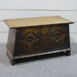 A good quality reproduction carved oak coffer of plank construction, width 2'11"