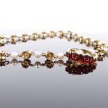 A 14ct gold pearl floral necklace, necklace length 40cm, 15.9g, and an 8ct gold garnet half hoop