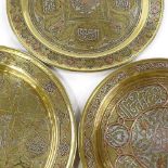 3 Islamic brass plates with silver and copper inlaid decoration and text, largest 31cm across (3)