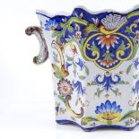 A French tin-glazed faience pottery jardiniere, with painted decoration and scroll handles, height