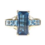 A 9ct gold blue topaz dress ring, with topaz set openwork shoulders, setting height 12.9mm, size