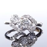 A platinum 3-stone diamond crossover ring, with diamond set shoulders, central stone approx 0.