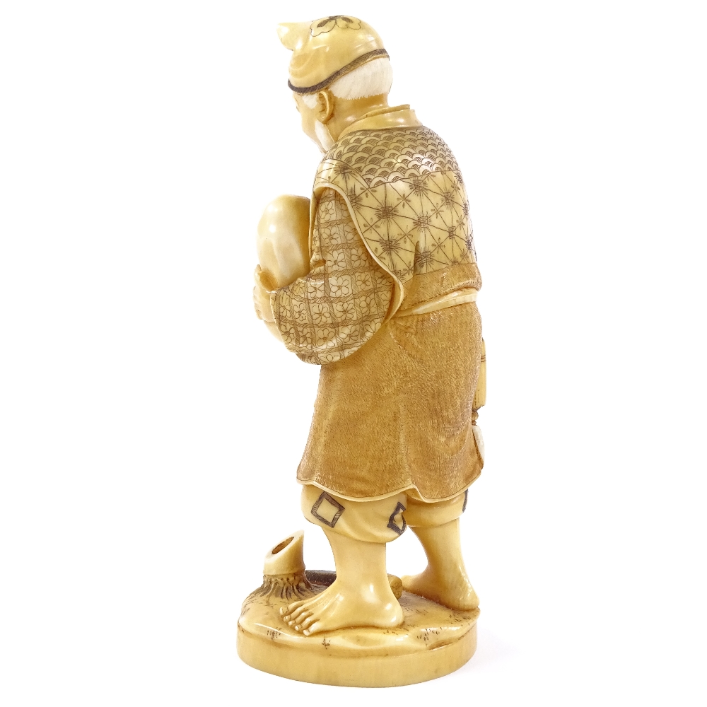 A Japanese 2-tone stained ivory okimono, man carrying an infant, Meiji period, signed under base, - Image 3 of 8