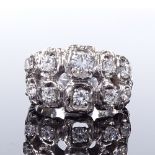 A 14ct white gold diamond cluster abstract ring, openwork settings and shoulders, largest diamond