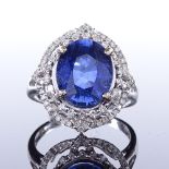 A 14ct white gold sapphire and diamond cluster ring, oval-cut sapphire approx 4.5ct, pierced