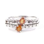 A 9ct white gold orange sapphire and diamond dress ring, openwork line settings, maker's marks DK,