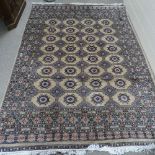A large cream ground Tekke wool rug, 310cm x 215cm