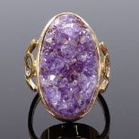 A large unmarked gold handmade amethyst geode panel dress ring, openwork shoulders, setting height