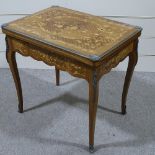 An Italian walnut and floral marquetry inlaid fold over games table, with ormolu mouldings and