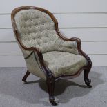 A Victorian carved and shaped mahogany-framed fireside armchair