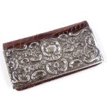 An Edwardian silver-mounted crocodile bi-fold lady's purse, with relief embossed foliate and