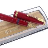 A Parker red-cased fountain pen with 14ct gold nib, boxed
