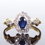 An 18ct gold sapphire and diamond cluster ring, with diamond set foliate shoulders, setting height