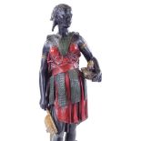A patinated and painted spelter figure of a West Indian woman carrying a pineapple, height 51cm