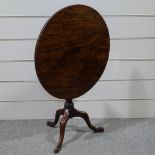 An early 19th century circular mahogany tilt-top tea table on tripod base, 29.5" across