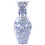 A Middle Eastern Islamic white glaze vase with painted blue floral decoration, height 55cm, rim