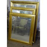 3 modern gilt-framed bevelled-edge wall mirrors