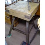 A small square butcher's block on cast-iron stand, block width 44cm, height 72cm