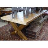 A large heavy and impressive plank-top rectangular refectory dining table, on an X-framed
