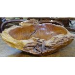 A large rustic and carved yew wood bowl, W65cm