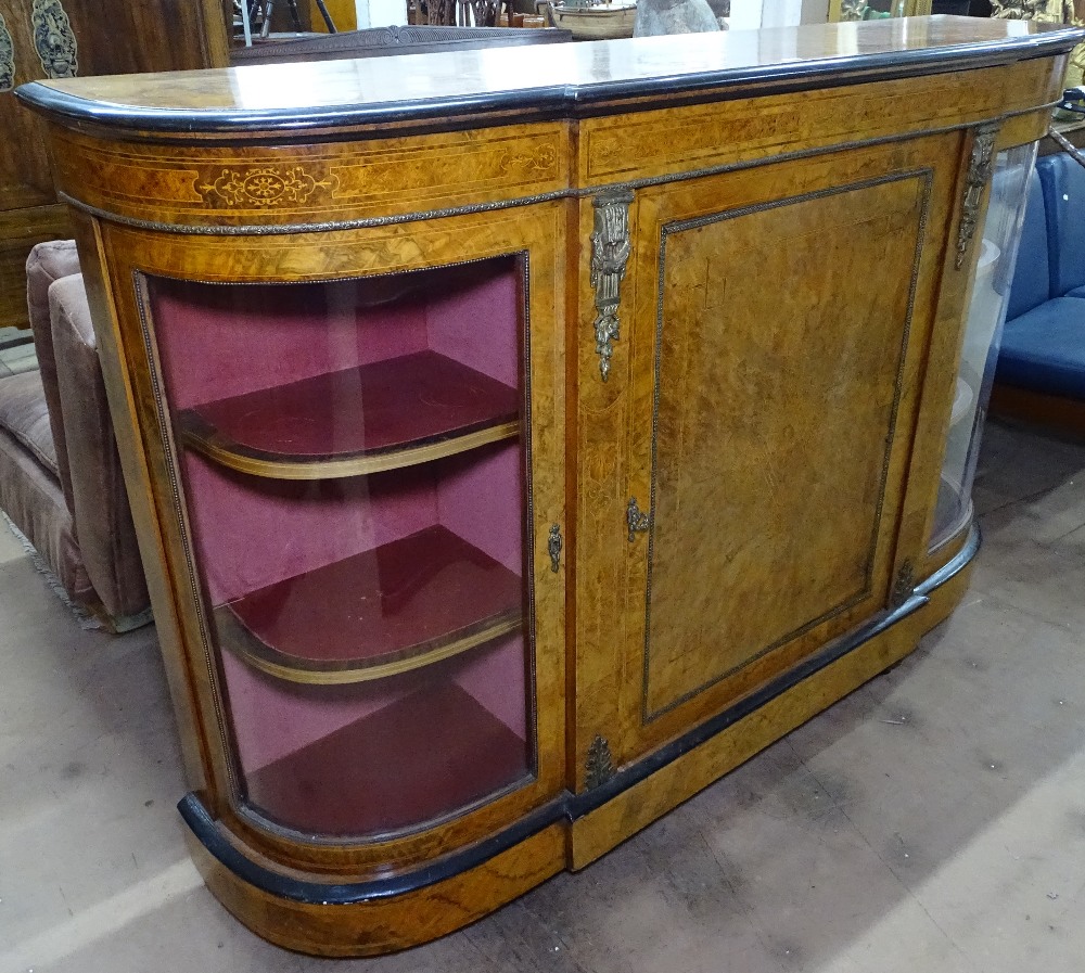 A Victorian burr-walnut and ebonised credenza, having bow-end glazed doors and centre panelled