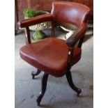 A 1920s studded rexine upholstered swivel desk chair