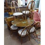 An Ercol elm drop leaf dining table, 125cm extended length, together with a set of 6 matching