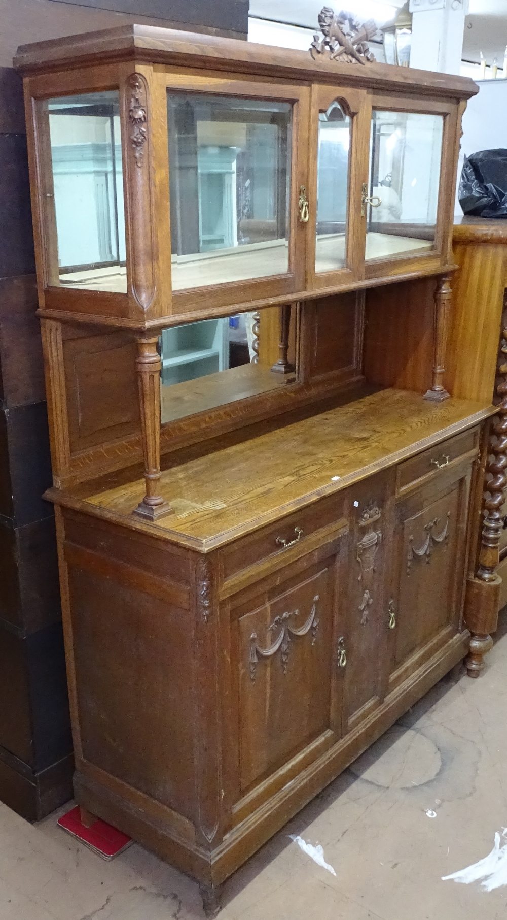 A French oak 2-section dresser, fitted with glazed and mirror-back drawers and cupboards to the