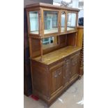 A French oak 2-section dresser, fitted with glazed and mirror-back drawers and cupboards to the