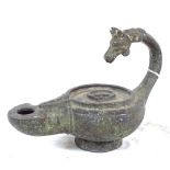 A cast-iron verdigris oil lamp, with horse-head handle, length 18cm