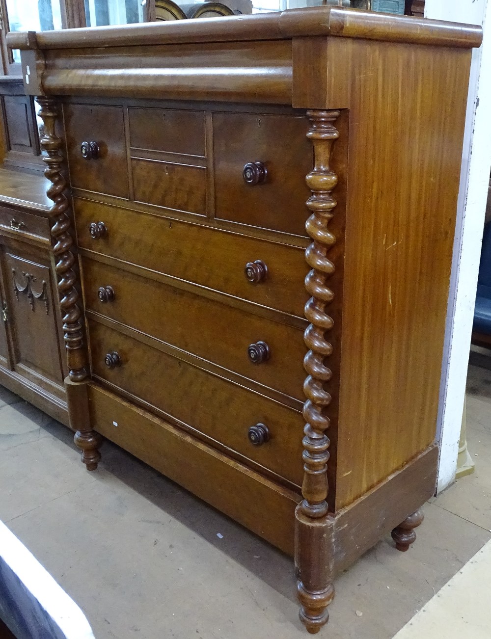 A large 19th century Scottish mahogany chest, having an ogee frieze drawer, with 8 further drawers