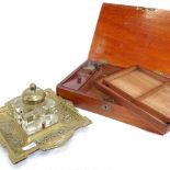 A mahogany writing box with fitted interior and inkwell, length 25.5cm, and a cast-brass desk