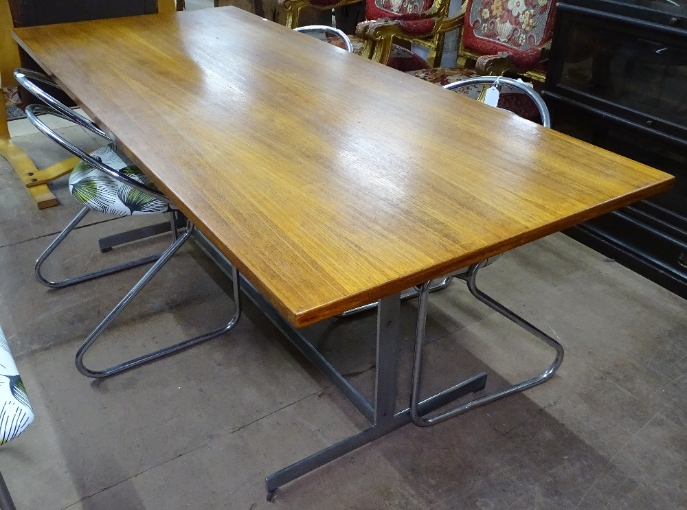 A 1960s teak dining table on flat bar steel base, L183cm, H69cm, D76cm