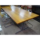 A 1960s teak dining table on flat bar steel base, L183cm, H69cm, D76cm