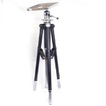 An adjustable chrome-mounted steel tripod