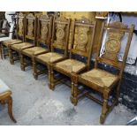 A set of 6 Breton dining chairs with figural carved panelled backs, drop-in seats, on turned legs