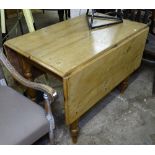 An Antique drop leaf pine kitchen table on baluster legs, W98cm