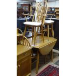 An Ercol design drop leaf table, a set of 4 stick-back chairs (2 and 2) and a Priory Furniture