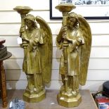 A pair of gilded fibreglass angel candle stands, height 69cm (some parts A/F)