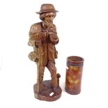 A carved wood figure of a man with a dog, and an Oriental carved bamboo brush pot, pot height