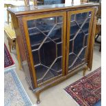 An Edwardian mahogany bookcase, with 2 lattice glazed doors, on cabriole legs, W107cm, H125cm